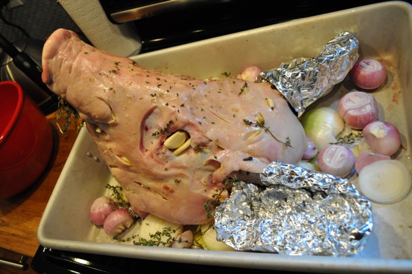Then we covered her ears in tin foil to stop them from burning in the oven, and put garlic and cloves into the slits made in her skin so the brine could seep into the meat.